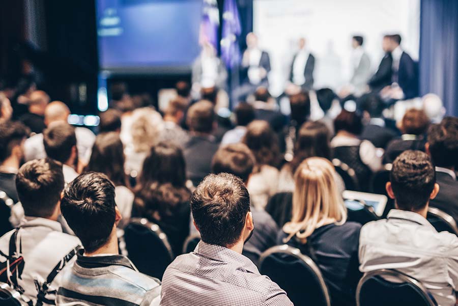 A slightly blurred image of a conference audience