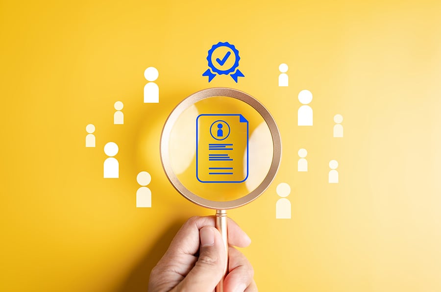 A magnifying glass is placed over a graphic of a certificate