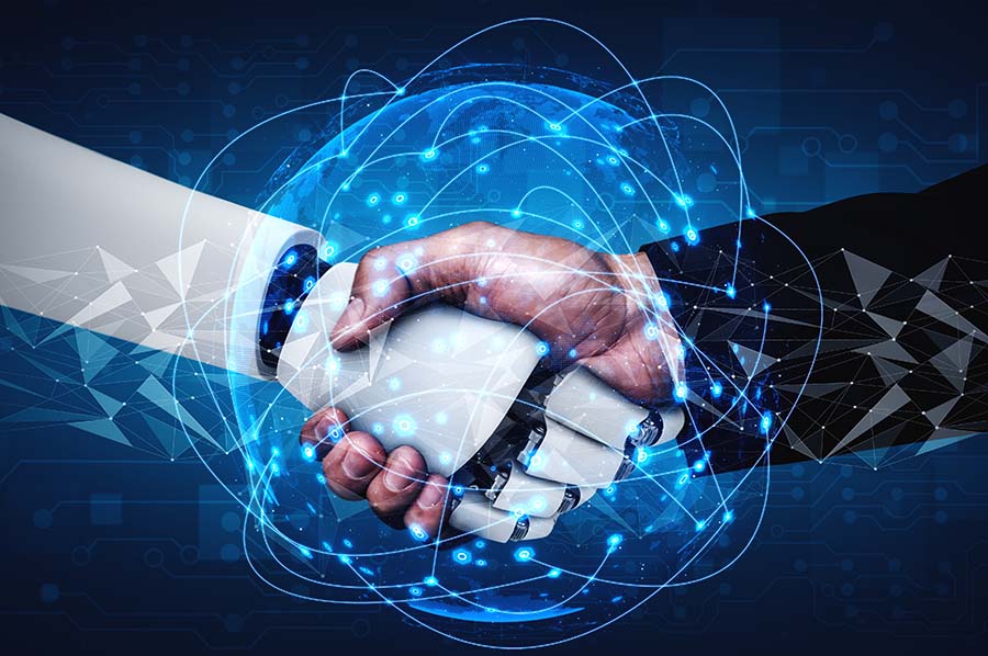 A close up of a handshake between a robot and a human hand
