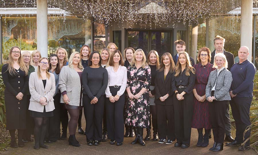 A wide-range group shot of the Smith & Co team