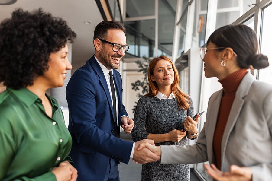 A group of smiling business associates in smart clothes