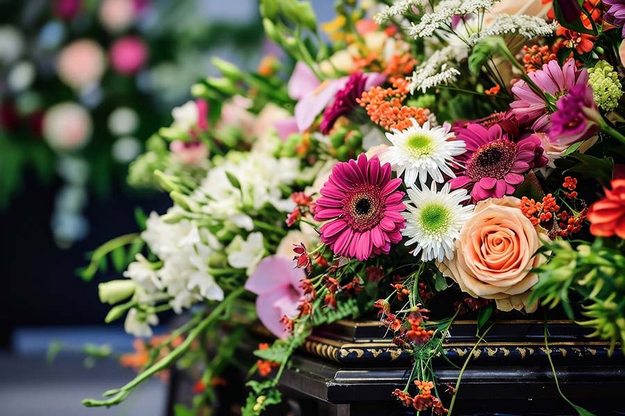 A close-up of a large bouquet of flowers on a coffin