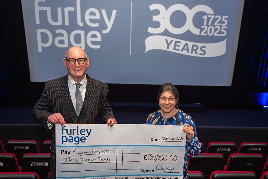 Furley page staff holding a giant cheque for £30,000