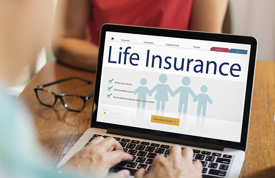 An open laptop with the words 'life insurance' on the screen