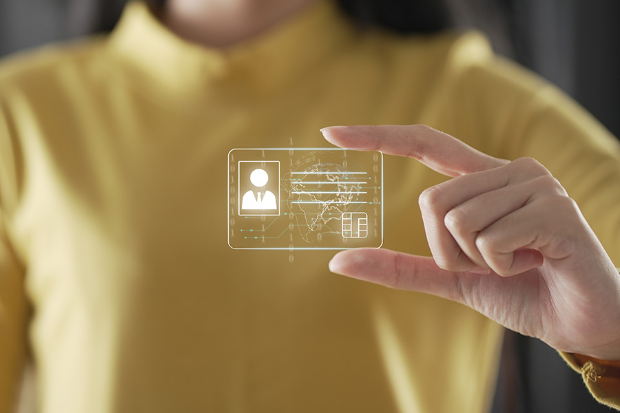 A woman appears to be holding up a holographic image of a digital ID card