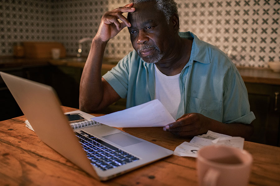 An older man using a laptop