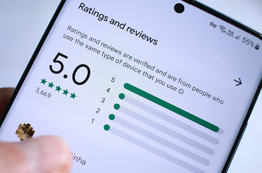 A close-up of a phone screen with a five star review