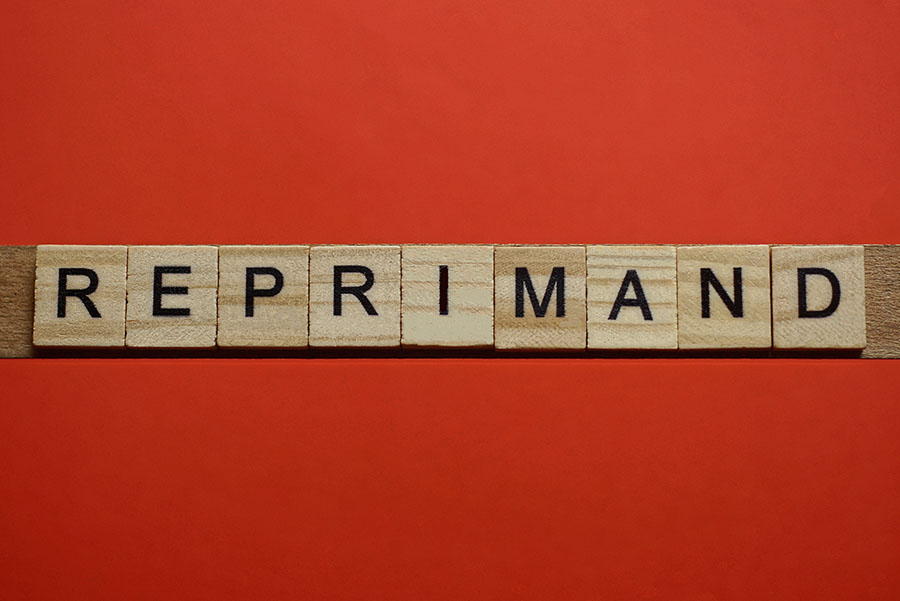 Wooden tiles spelling out the word reprimand