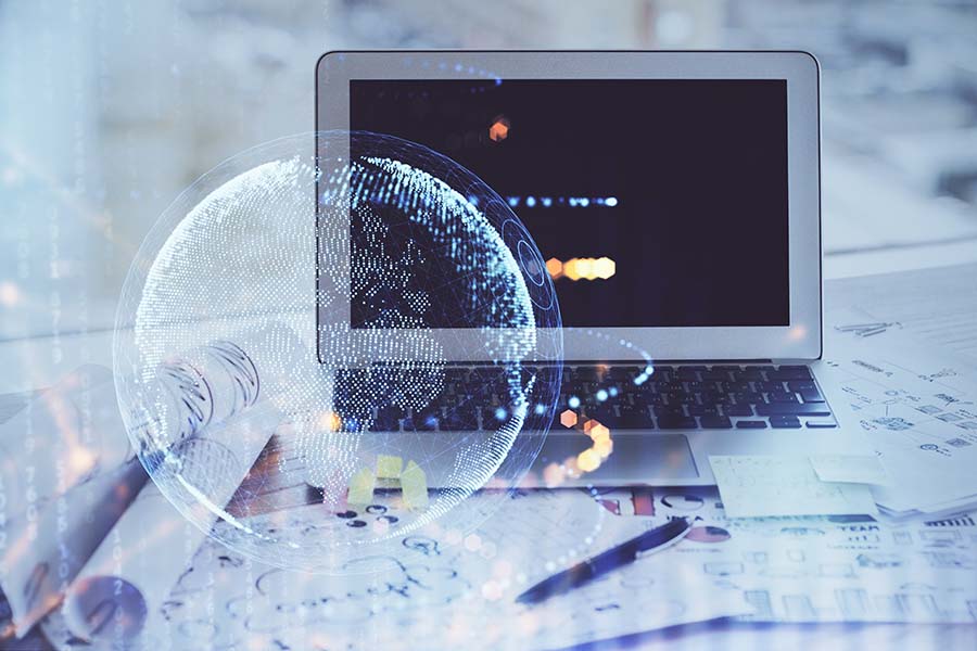 A laptop is overlaid with a graphic of a globe in white neon