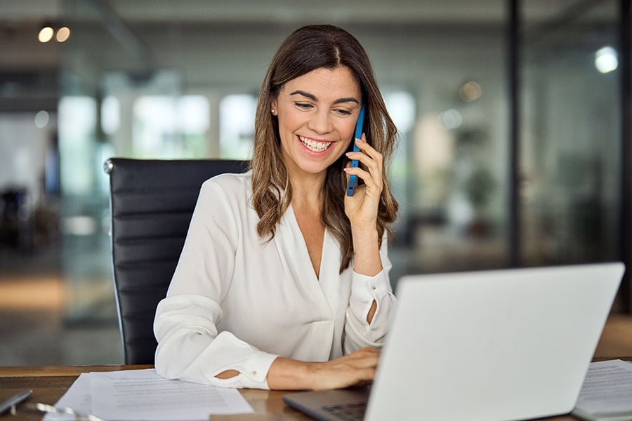 A smiling professional woman talking on the phone