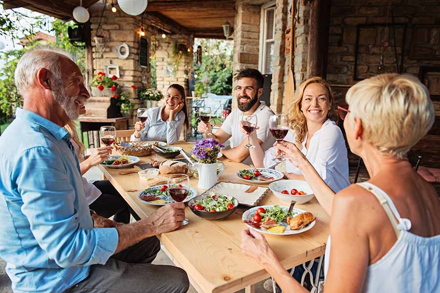 A family enjoy a meal outdoors in Italy