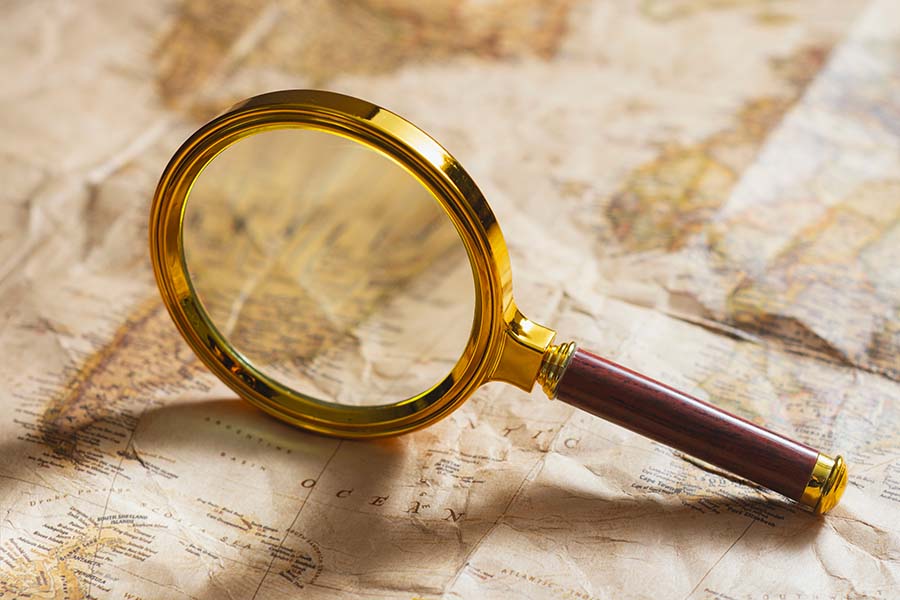 A magnifying glass placed over a map