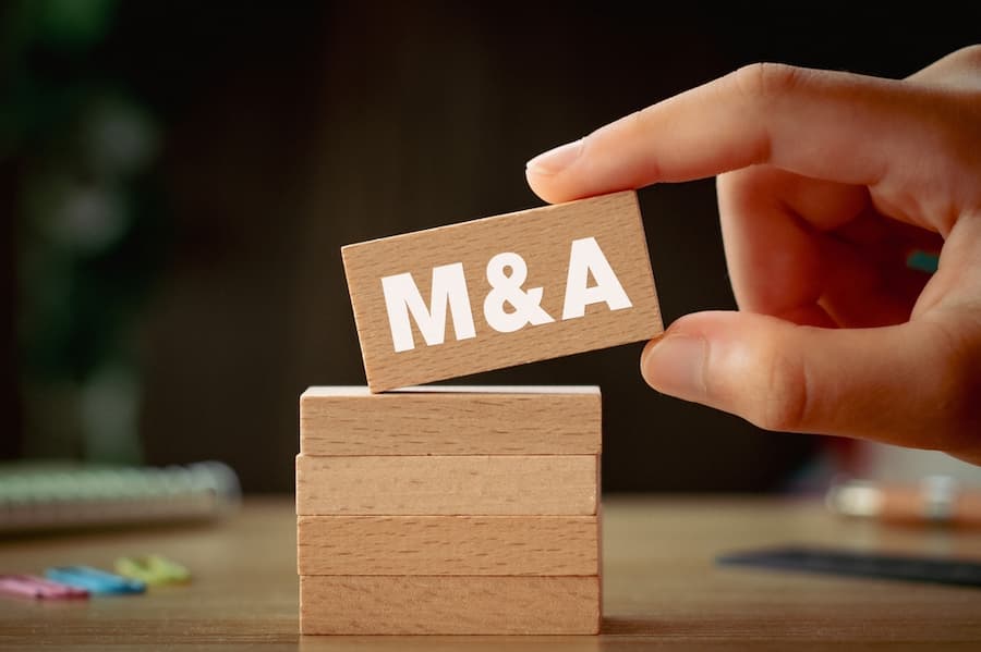 stacked wooden blocks with M&A written on them