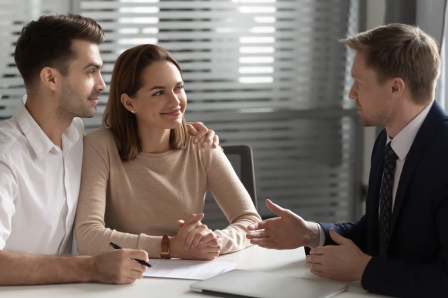 Confident advisor consulting young couple about estate planning