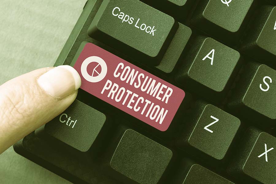 A keyboard with the words 'consumer protection' written on one of the keys