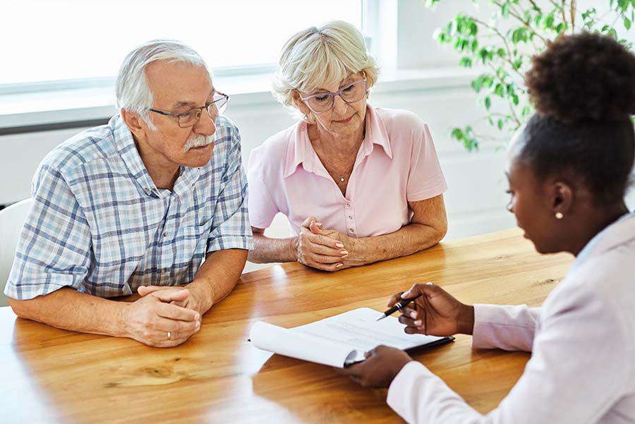 A financial adviser showing paperwork to an older couple