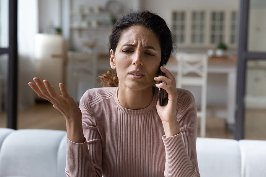 A frustrated looking woman on the phone