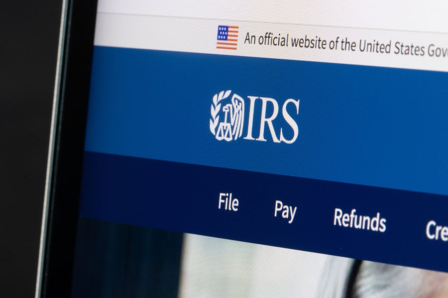 A photo of the IRS website displayed on a screen