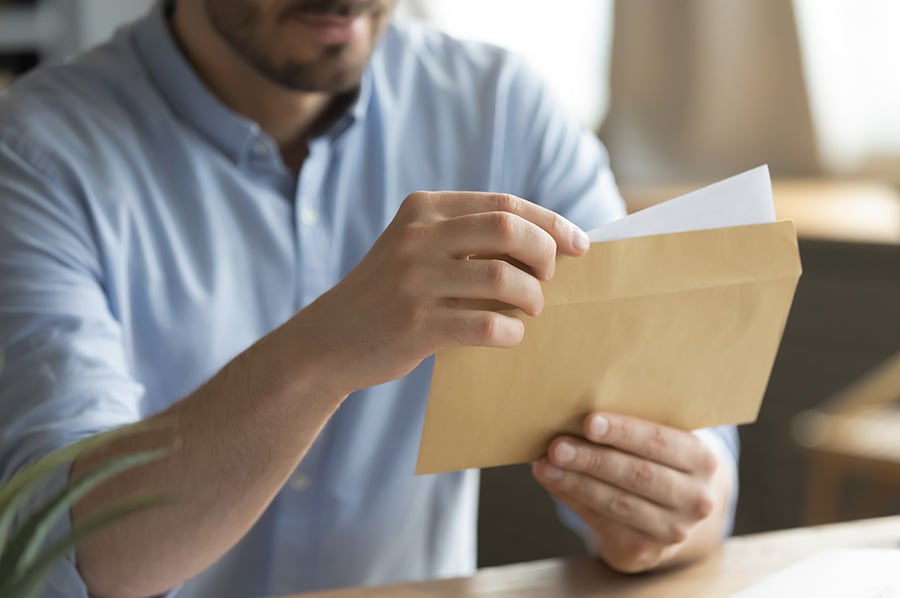 A man opening a letter