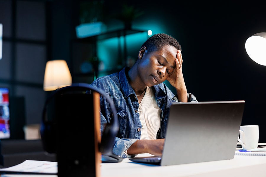 A worried woman using a laptop