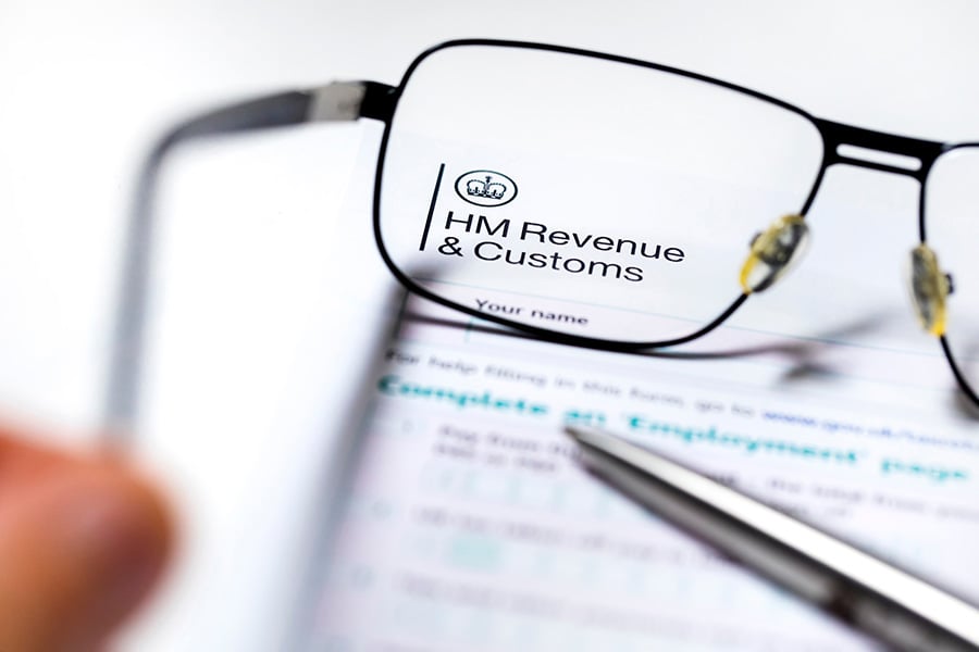 HMRC letterhead, with a pair of reading glasses and pen placed on top