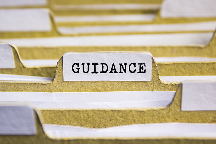 Files in a drawer with the tab marked with the word guidance