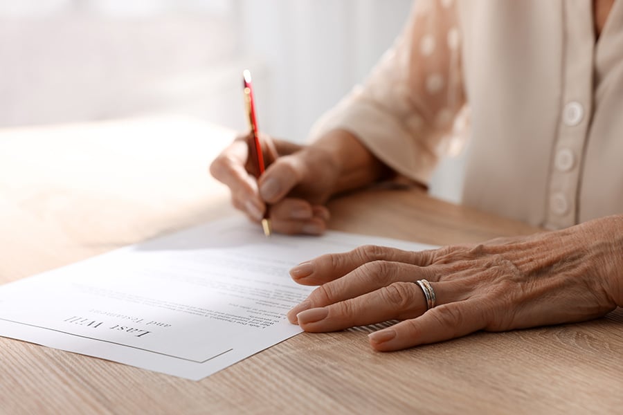 old woman signing a will