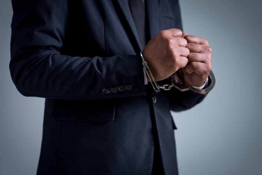 Man in suit with handcuffs